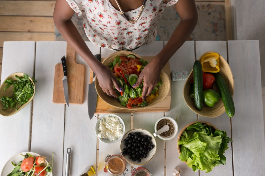Young African Woman Cooking Salad
