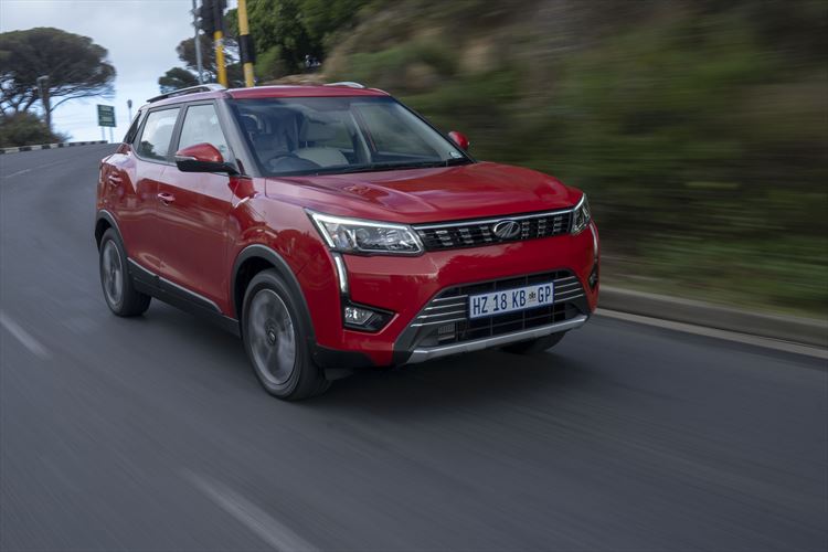 a red Mahindra suv