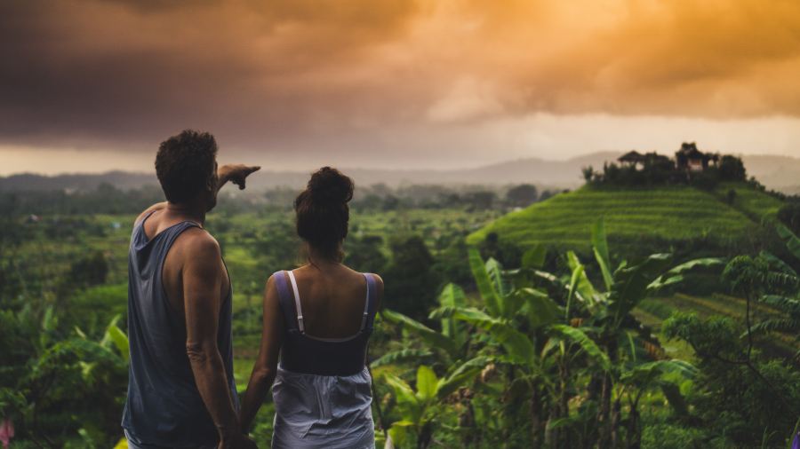 a couple standing in the sunset