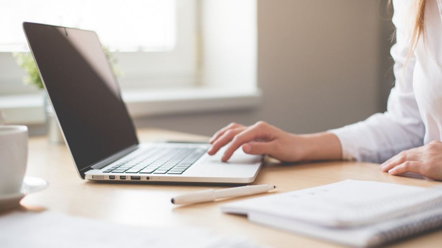 A women's hand on a laptop