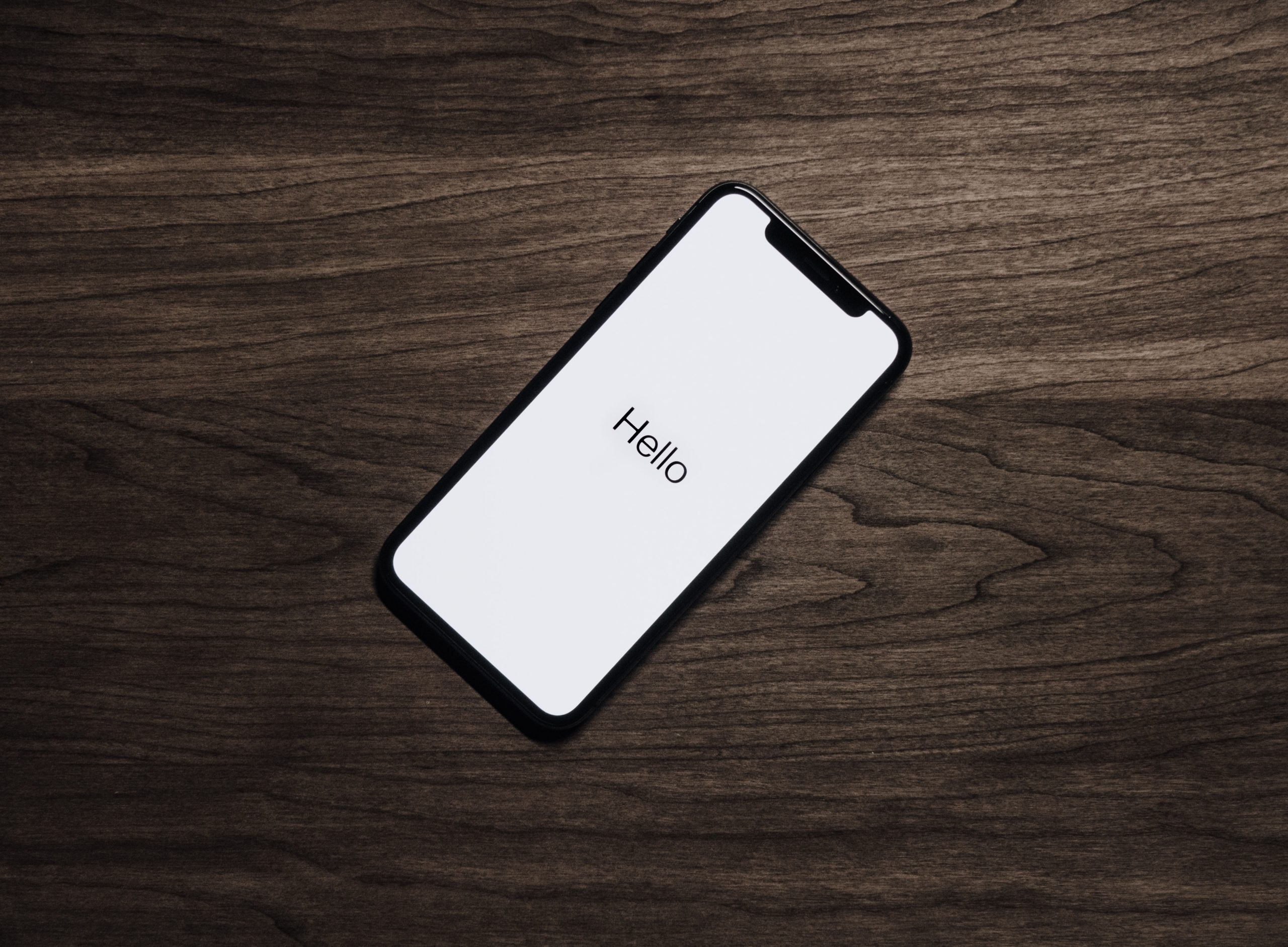 black-iphone-7-on-brown-table-699122