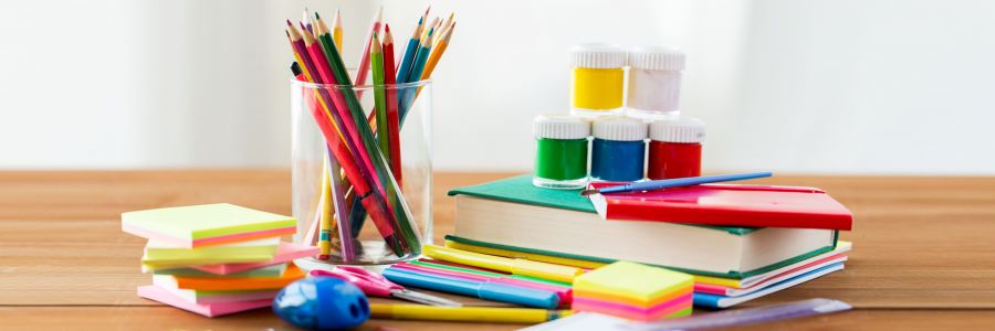 pencils- books on a wooden table
