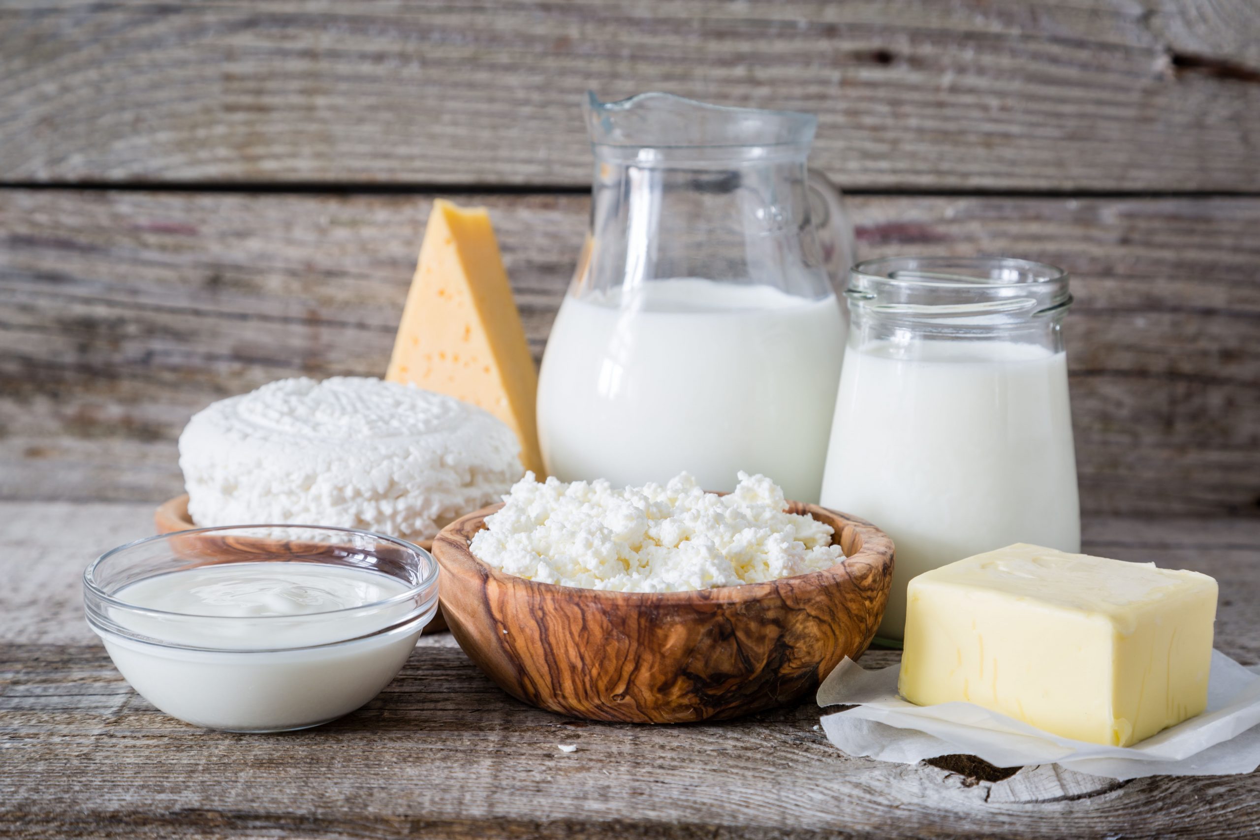 Selection of dairy products on rustic wood background, copy space