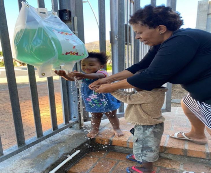 a women and child washing their hands