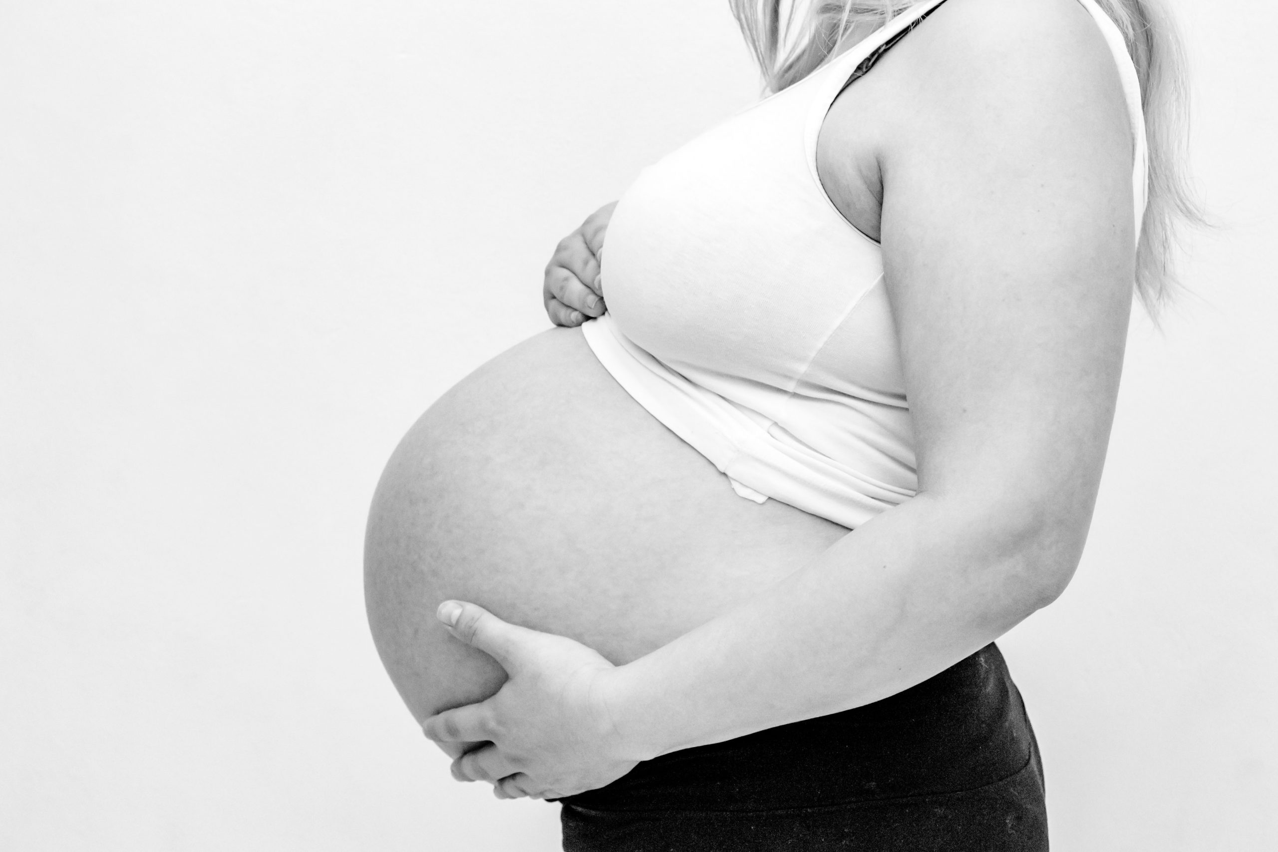 woman-holding-her-baby-bump