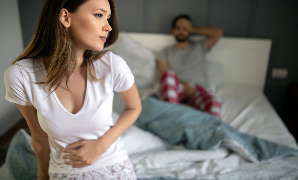 sad-upset-unhappy-woman-holding-hands-on-stomach