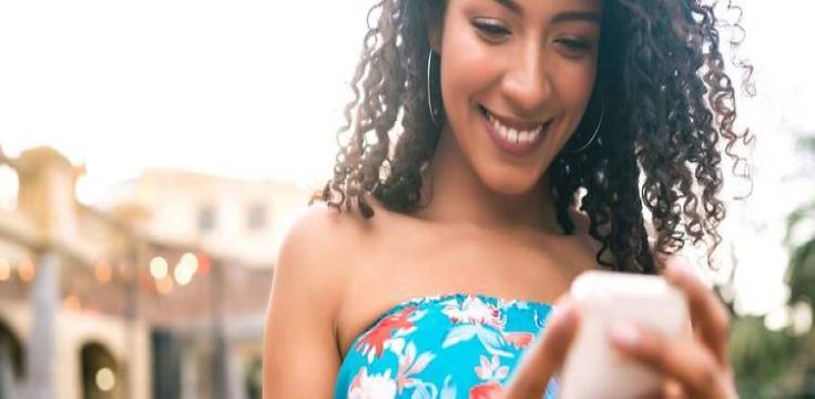 a female holding a smartphone