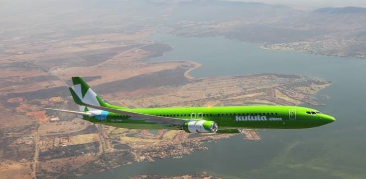 a green aeroplane in the sky