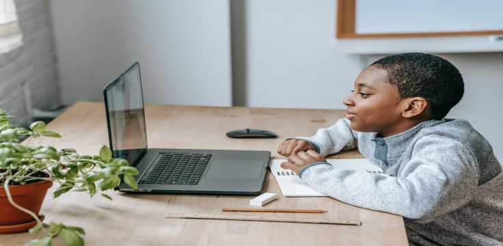 black-boy-watching-video-on-laptop