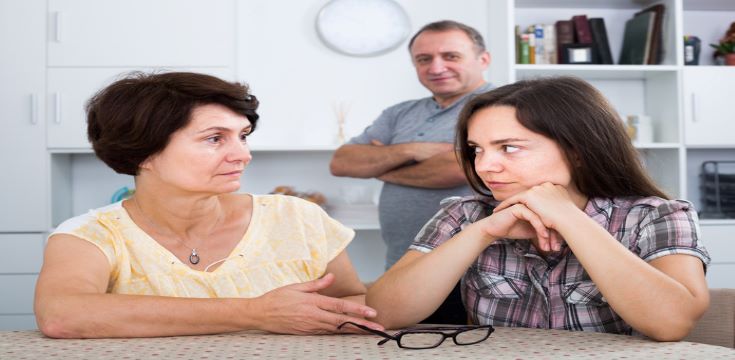 mature-couple-at-table-with-adult-child