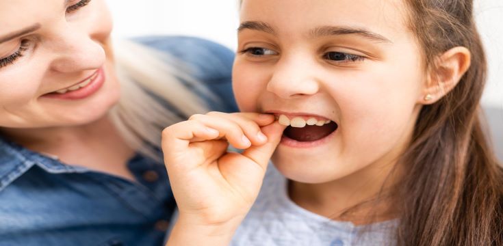 cute-young-child-holding-her-tooth-which-may-be-loose-aching