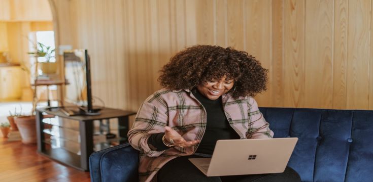 female-sitting-on-a-couch-using-laptop-computer