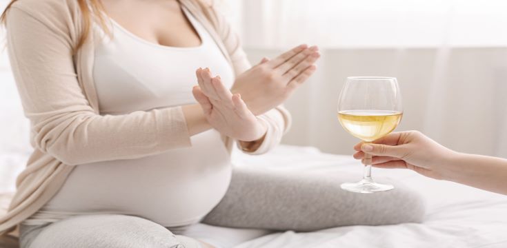 pregnant-woman-with-crossed-hands-refusing-to-drink