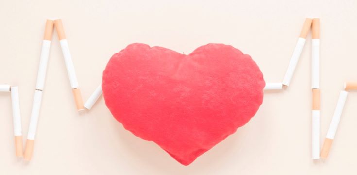 top-view-heart-surrounded-by-cigarettes