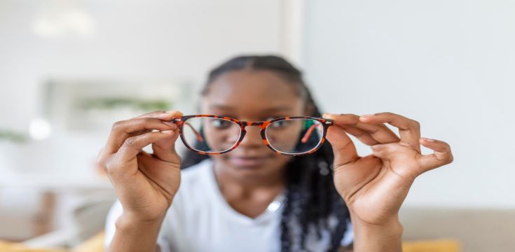 young-african-woman-holds-glasses-with-diopter-lenses-looks-through-them-problem-myopia-vision-correct
