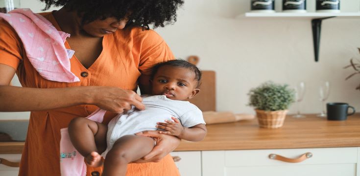 Woman Carrying a Baby Boy