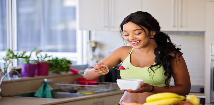 Woman-smiling-eating-healthy-food