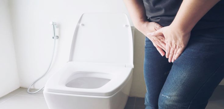 woman-holding-hand-near-toilet-bowl-health-problem-concept
