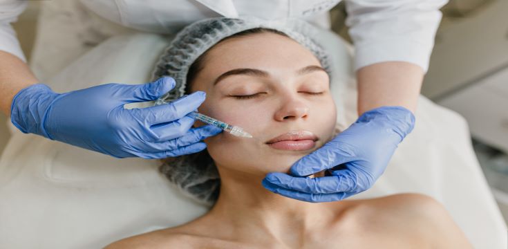 portrait-young-woman-during-cosmetology-procedures-beauty-salon-injecting-botox-hands-blue-glows-healthcare-therapy-lips-beauty