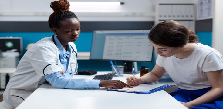 woman-patient-signing-medical-documents-discussing-medication-treatment