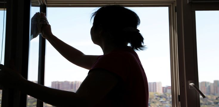 Silhouette of woman cleaning