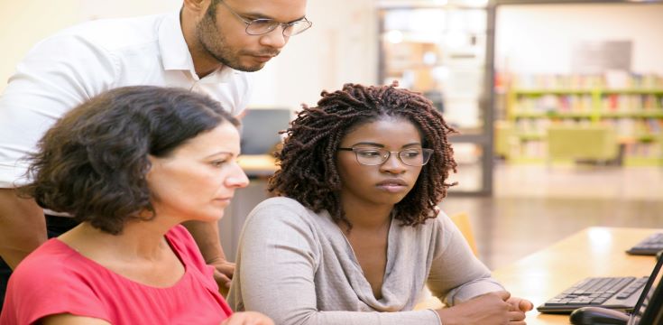 adult-female-students-consulting-instructor