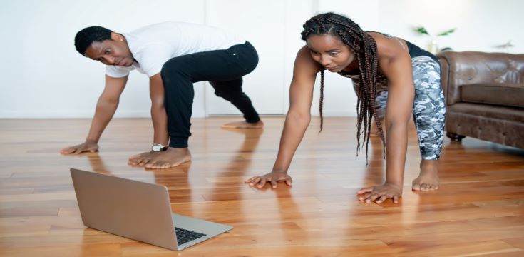 couple-doing-exercise-together-watching-video-tutorial-laptop-while-staying-home-sport-concept-new-normal-lifestyle-concept