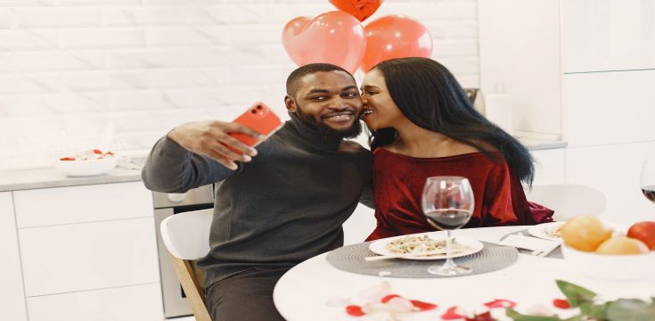 couple-sitting-table-having-meal-talking-laughing-valentine-s-day
