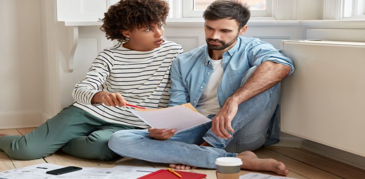 displeased-dark-skinned-businesswoman-convinces-her-husband-pay-attention-some-figures-financial-report