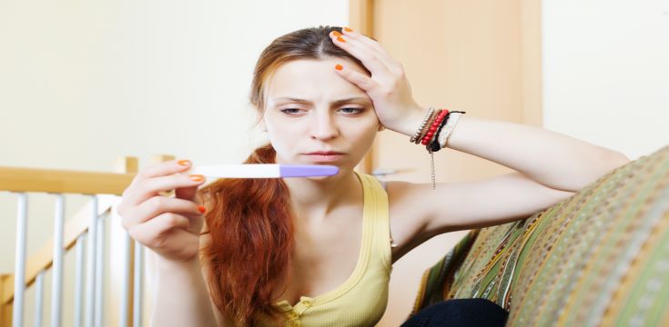 serious-girl-with-pregnancy-test