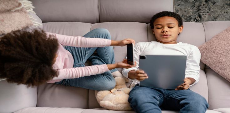 siblings-using-tablet-mobile-home