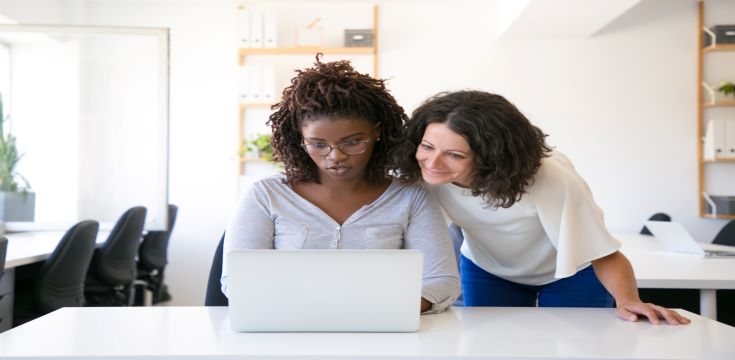excited-female-colleagues-watching-content-monitor
