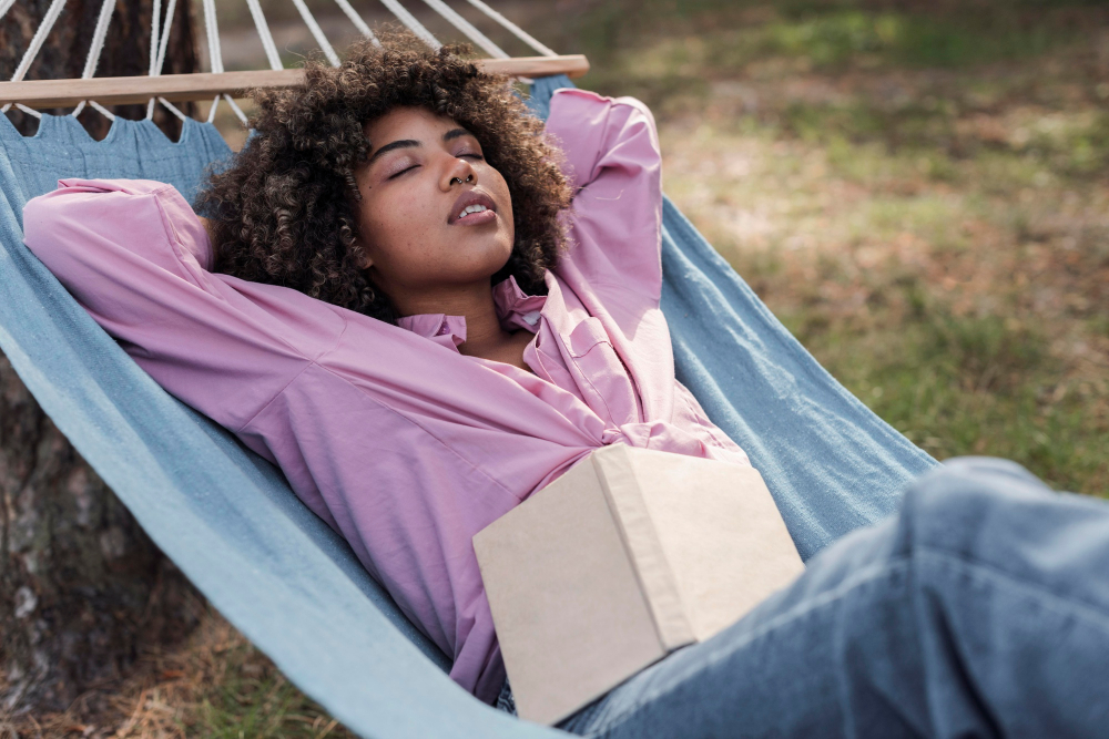 woman-relaxing-hammock-while-camping-outdoors-with-book