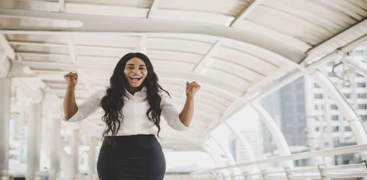 young-business-woman-achieve-goal-raised-hands