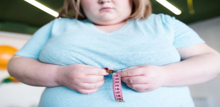 young-woman-measuring-her-waist