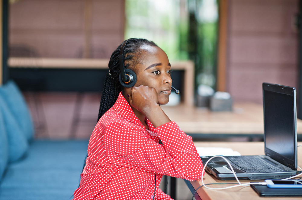 african-american-woman-works-call-center-operator-customer-service-agent-wearing-microphone-headsets-working-laptop