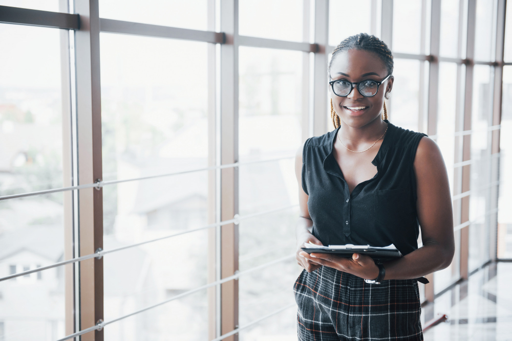 thoughtful-african-american-business-woman-wearing-glasses-holding-documents