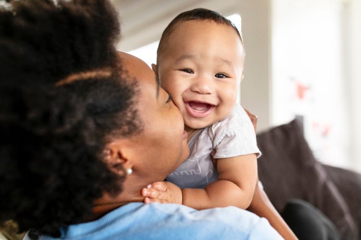 happy-african-american-mother-kissing-her-son