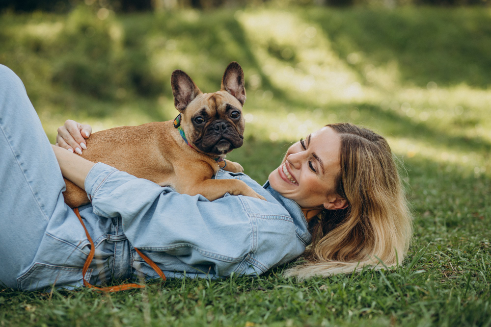young-woman-with-her-pet-french-bulldog-park