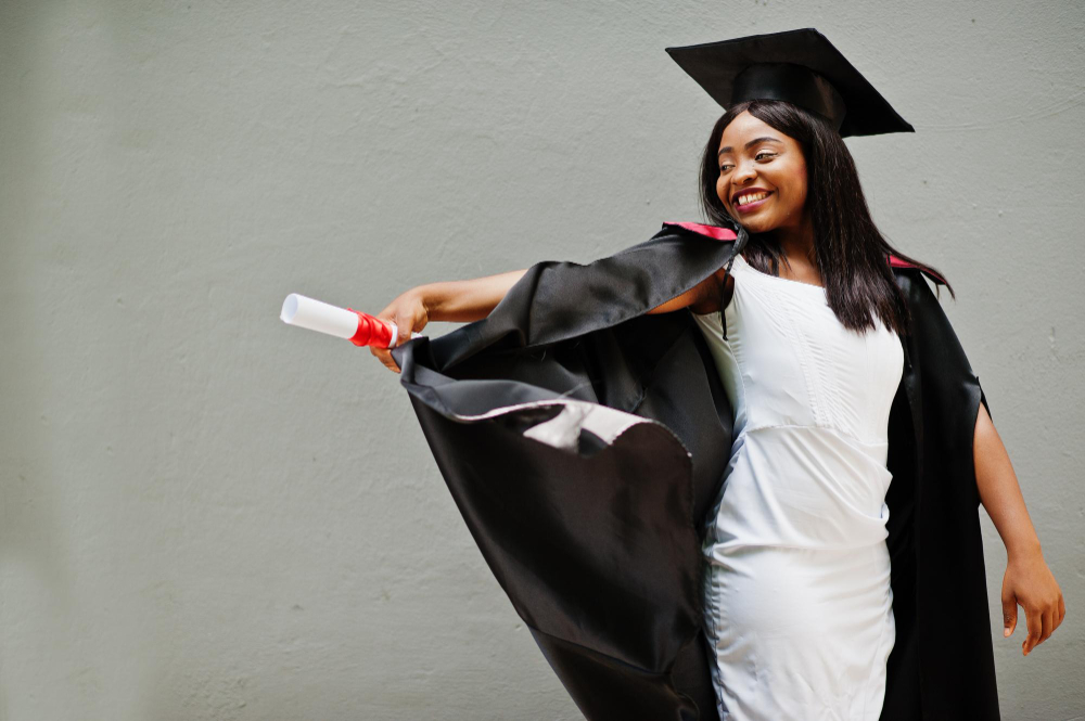 young-female-african-american-student-with-diploma-poses-outdoors