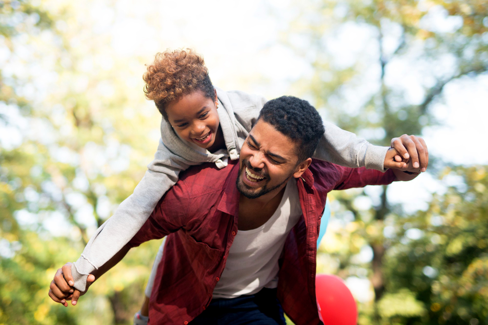 father-carrying-daughter-his-back-with-arms-spread