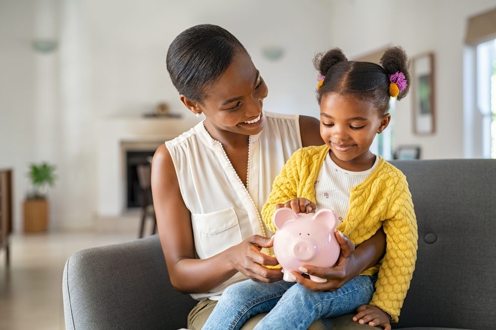 Smiling,Mature,African,American,Mother,Helping,Daughter,Sitting,On,Lap