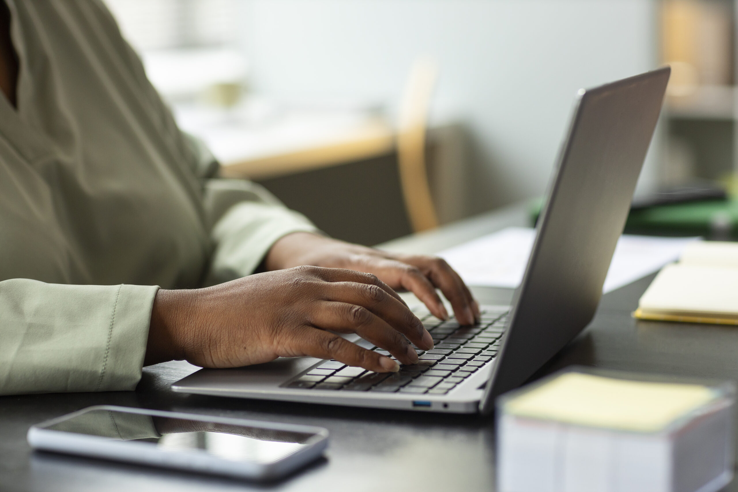 side-view-worker-typing-laptop