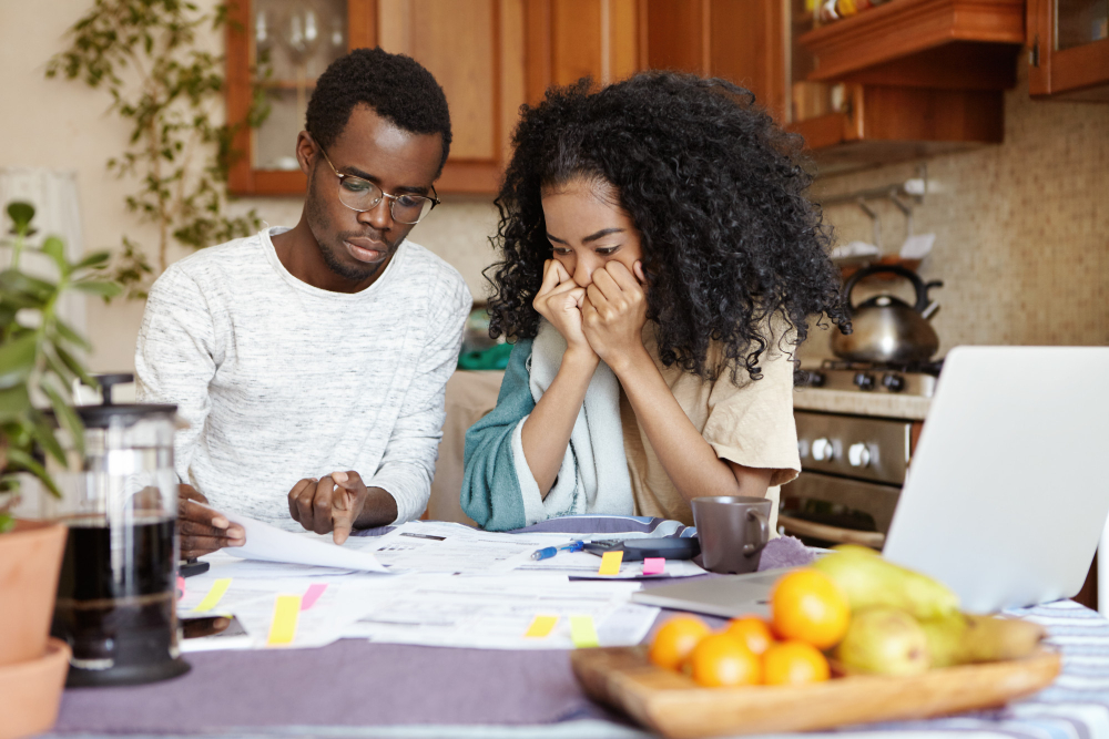 stressed-young-african-wife-holding-hands-her-face-listening-desperation-her-husband-reading-notification-informing-that-they-have-move-out-their-aparment-because-non-payment