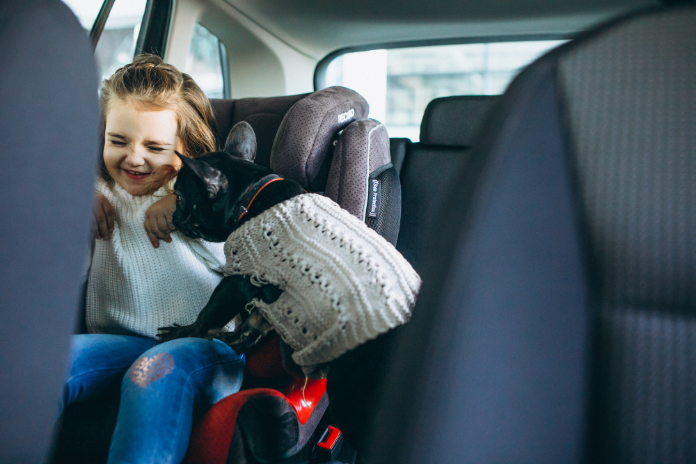 cute-little-girl-with-her-pet-sitting-back-car