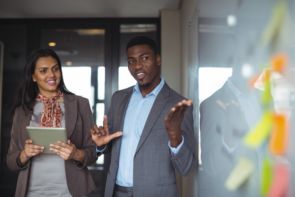 businessman-discussing-white-board-with-colleague