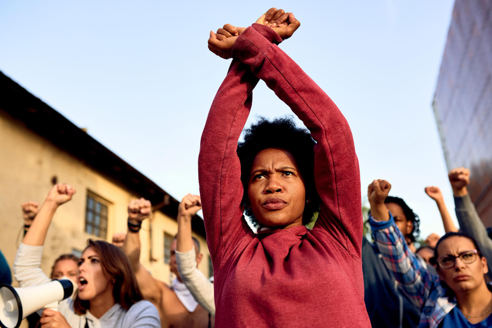 low-angle-view-african-american-woman-with-armcrossing-gesture-participating-protest-human-rights