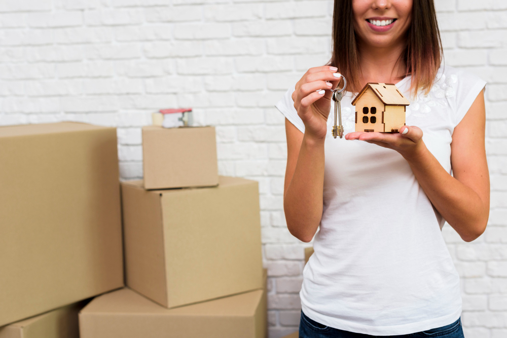 smiley-woman-holding-wooden-cottage-keys